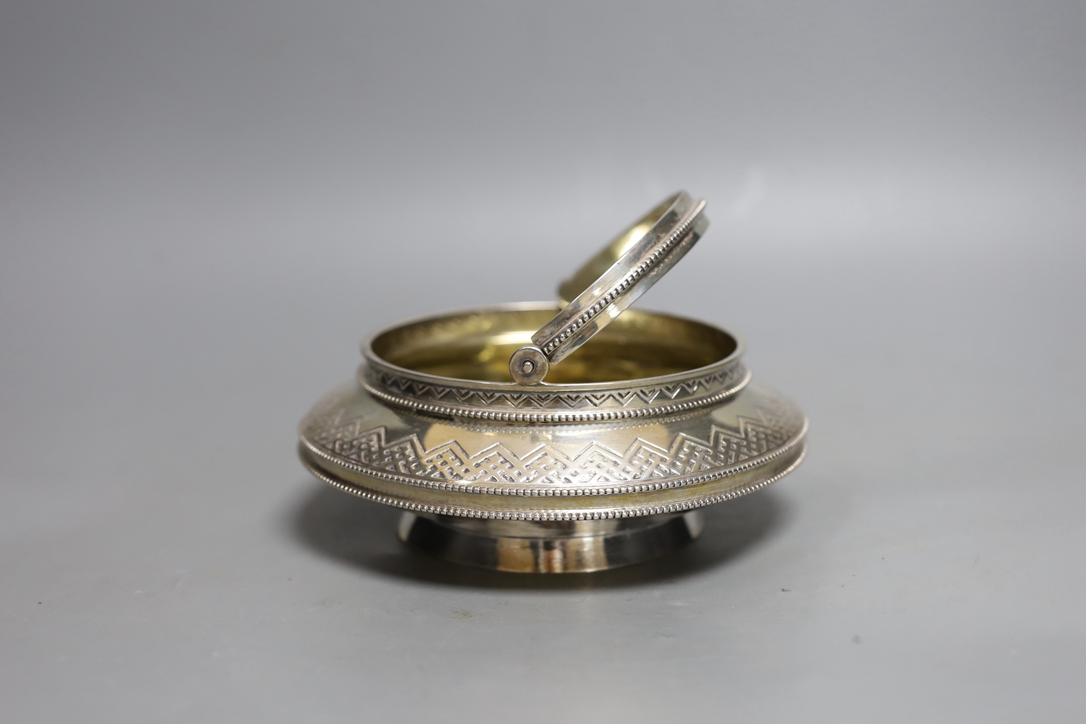 A late 19th century Russian 84 zolotnik sugar basket, of squat circular form, master Aron Berg?, dated 1875, diameter 17cm, 14.6oz.